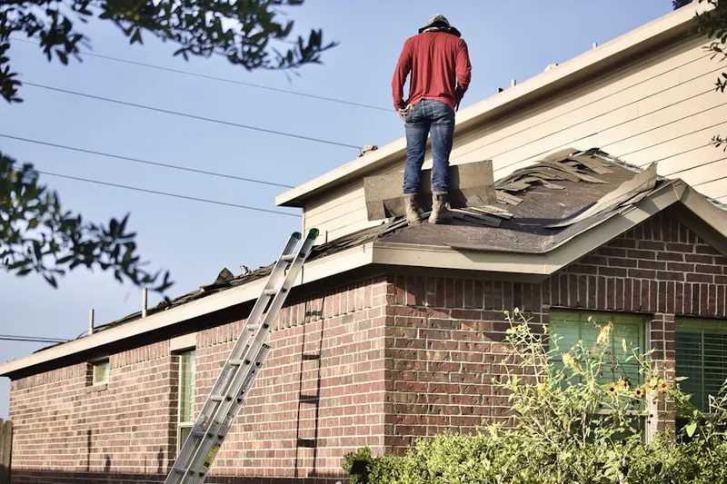 Professional roofer working on a residential roof in Enhaut